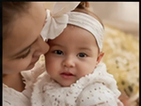 Baby portrait with a parent nearby