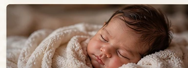 Close newborn portrait with warm neutral styling