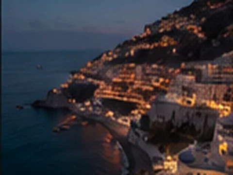 Seaside town descending toward the water at dusk